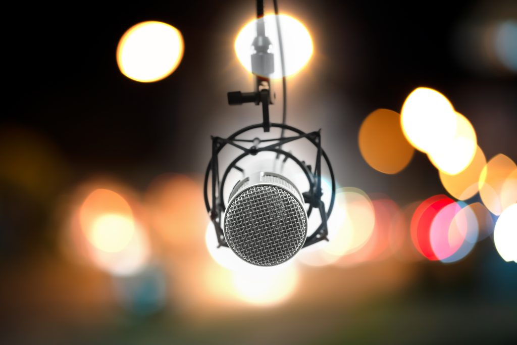 recording studio microphone in front of blurred bokeh background of a recording studio for professional voice recordings and audio