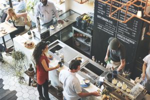 Top Down view of cafe restaurant with servers and patrons - Harmonizing Dining with Overhead Music and Messaging: A Symphony for Success in Restaurants